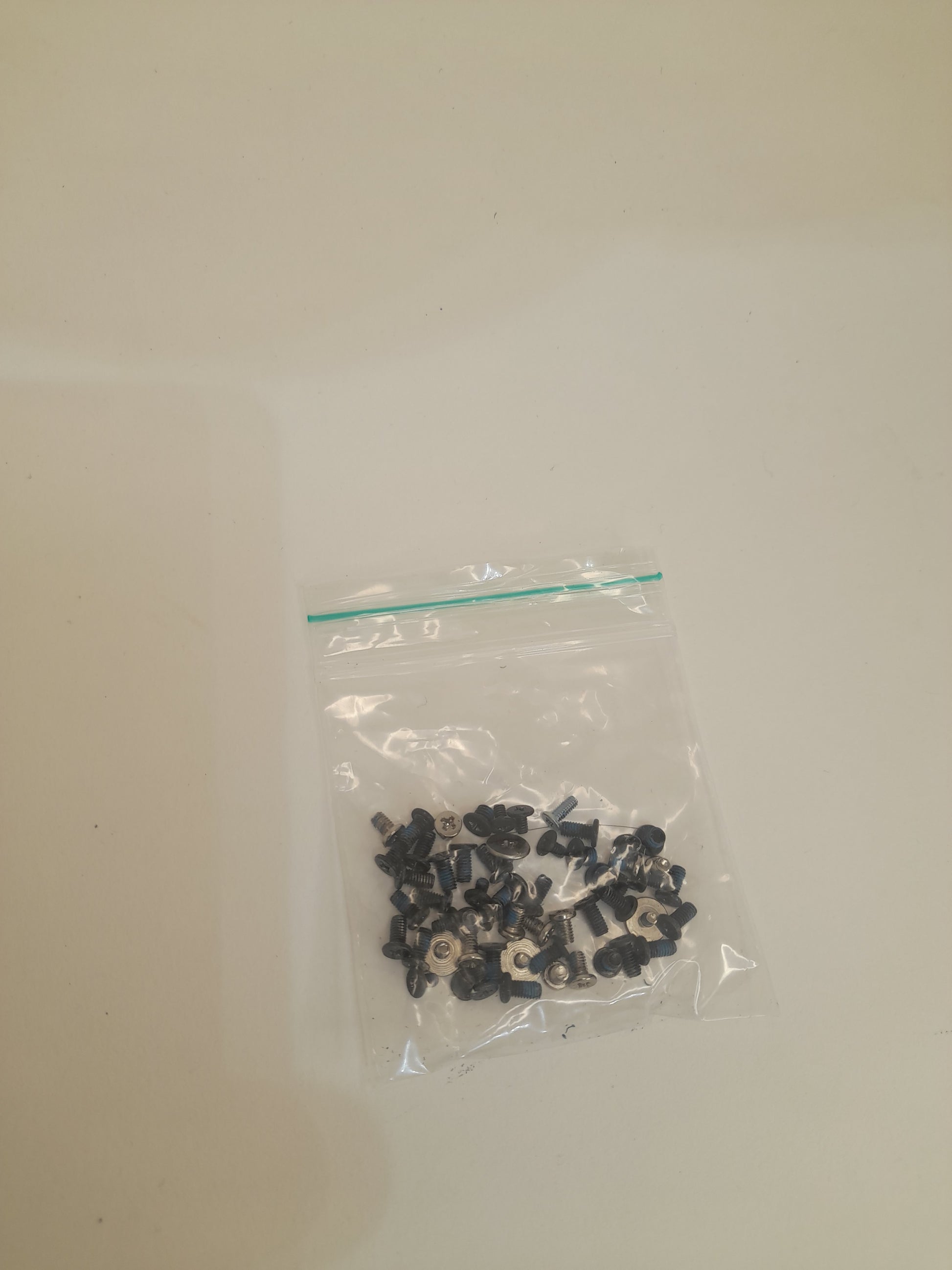 Small black objects in a clear plastic bag on a beige background