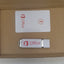 USB drive with Office branding on a cardboard surface