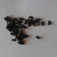 A collection of various sized metal screws, presumably for internal and external use in a Dell XPS 15 L501X laptop.